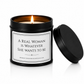 A black metal candle tin with a lit candle inside, shown next to its matching black lid on a white background. The front label reads, 'A REAL WOMAN IS WHATEVER SHE WANTS TO BE' 