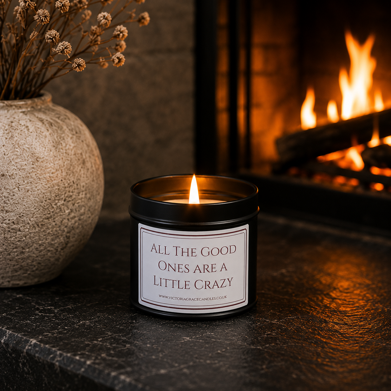 Funny soy wax candle creating a warm atmosphere beside a glowing fireplace in a cosy living room.