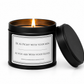 Luxury soy candle displayed on a dressing table with elegant cosmetics and a softly blurred woman applying makeup in the background.