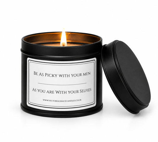 Luxury soy candle displayed on a dressing table with elegant cosmetics and a softly blurred woman applying makeup in the background.