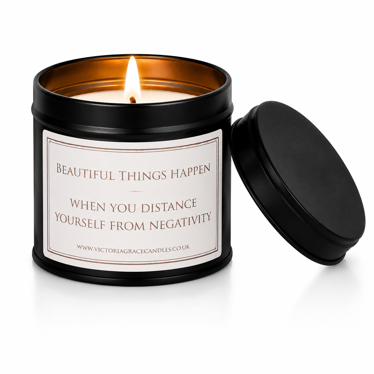 Luxury black soy wax candle with the words "Beautiful Things Happen When You Distance Yourself From Negativity" displayed on a white background with the black lid resting beside the candle.
