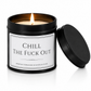 Luxury black soy wax candle with the words "Chill The Fuck Out" displayed on a white background with the black lid resting beside the candle.