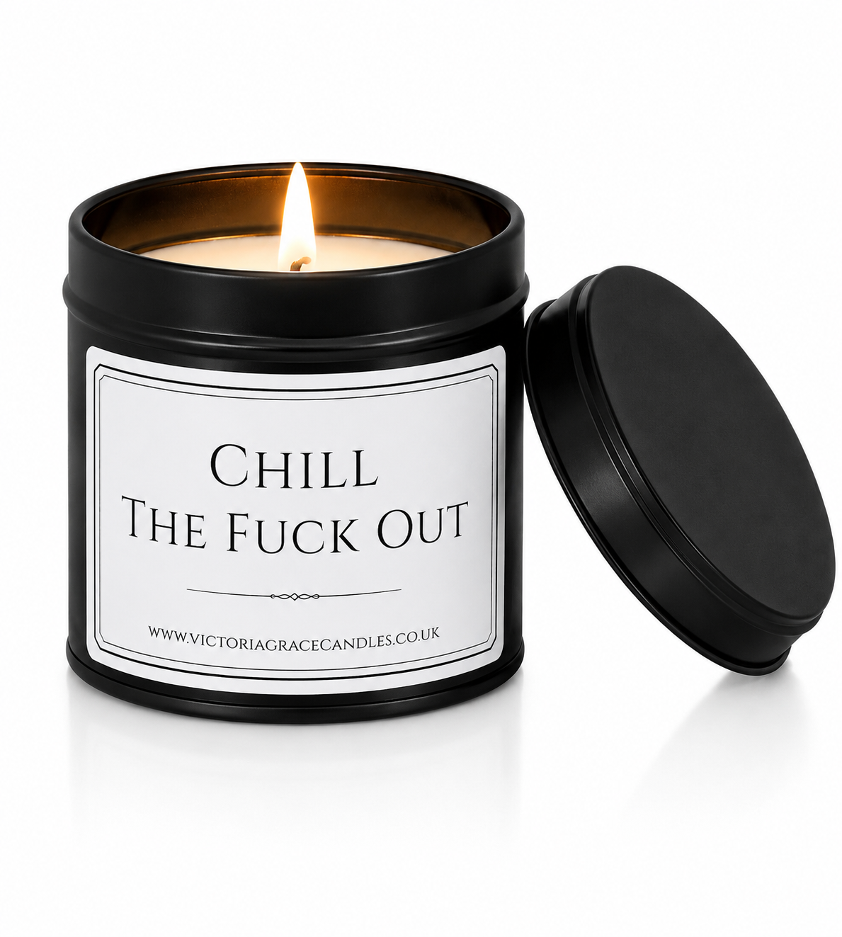 Luxury black soy wax candle with the words "Chill The Fuck Out" displayed on a white background with the black lid resting beside the candle.