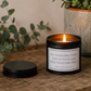 Luxury inspirational soy wax candle displayed on a rustic wooden table with eucalyptus and a textured ceramic plant pot, creating a calm and uplifting atmosphere.