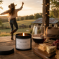 black tin candle with the words don't let others get you down on is in a sunset setting with a cowgirl dancing in the back ground