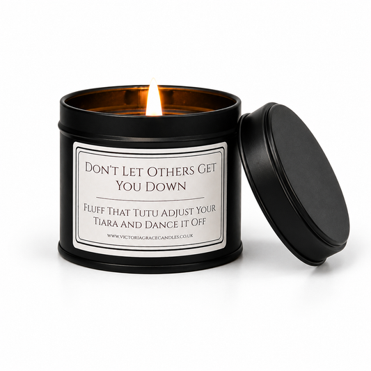 black tin candle set on a white background with the words don't let other get you down on it