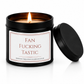 Luxury black soy wax candle with the words "Fan Fucking Tastic" displayed on a white background with the black lid resting beside the candle.