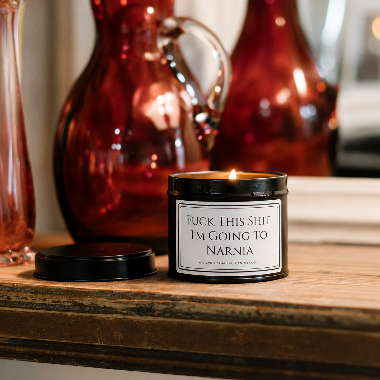 Luxury soy wax candle displayed on a rustic wooden table with warm amber glass vases in the background.