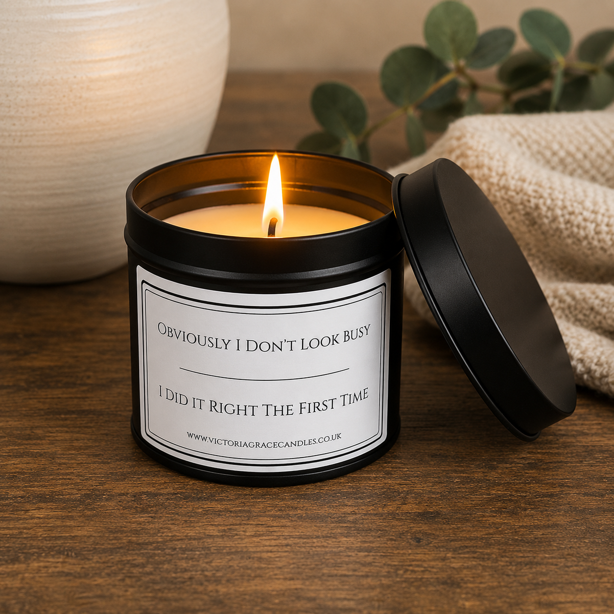 Lit Victoria Grace Candles soy wax candle with "Obviously I Don't Look Busy, I Did It Right the First Time" label in a warm, cosy home setting.