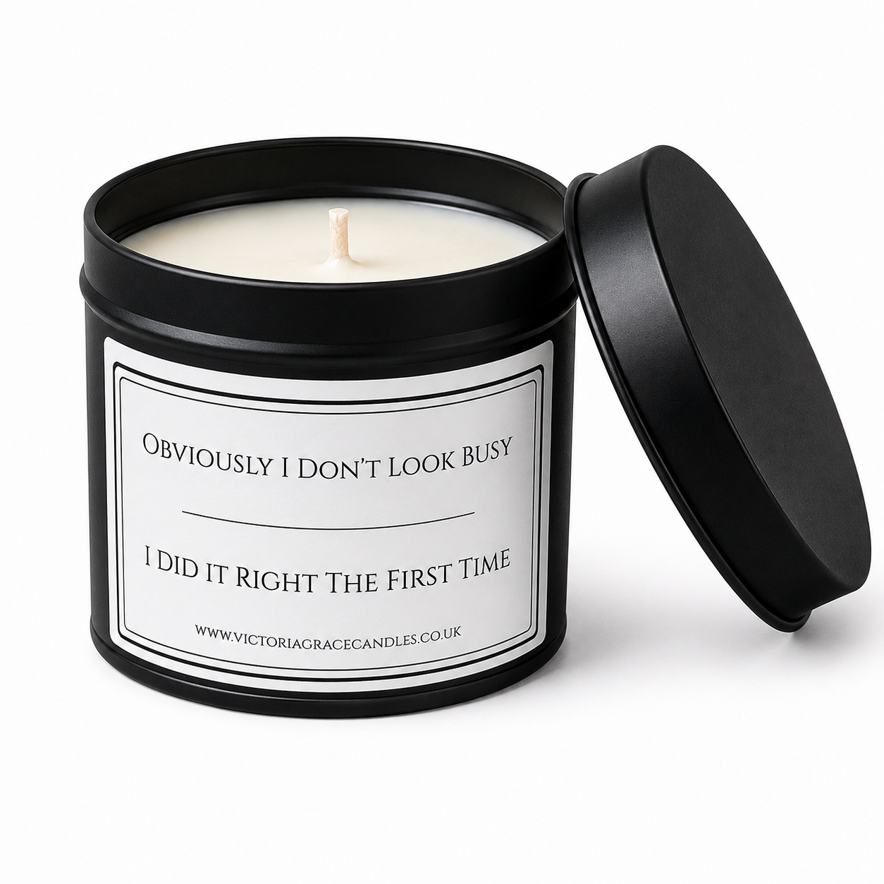 Victoria Grace Candles "Obviously I Don't Look Busy, I Did It Right the First Time" soy wax candle in a matte black tin on a white background.