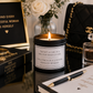 A lit candle in a black jar with a white label reading, 'I'M NOT A ONE IN A MILLION KIND OF GIRL. I'M ONCE IN A LIFETIME KIND OF WOMAN.