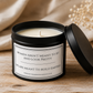Women Build Empires soy candle in an open matte black tin styled on a rustic wooden table with soft neutral home décor.
