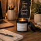 Luxury motivational soy wax candle in a modern office setting with a laptop, stationery and calming décor, ideal for productive working.
