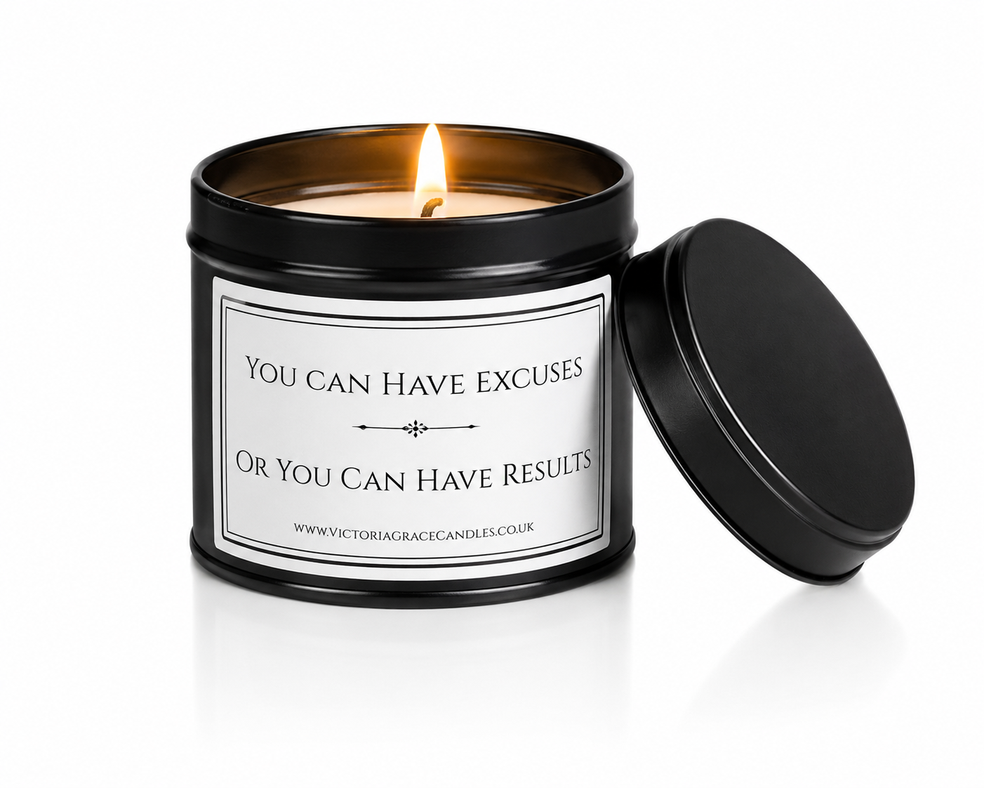 Luxury black soy wax candle with the words "You Can Have Excuses or You Can Have Results" displayed on a white background with the black lid leaning against the right-hand side of the candle.