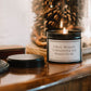 Luxury soy wax candle displayed in a warm, elegant home with pine cones in the background creating a calming and empowering atmosphere.